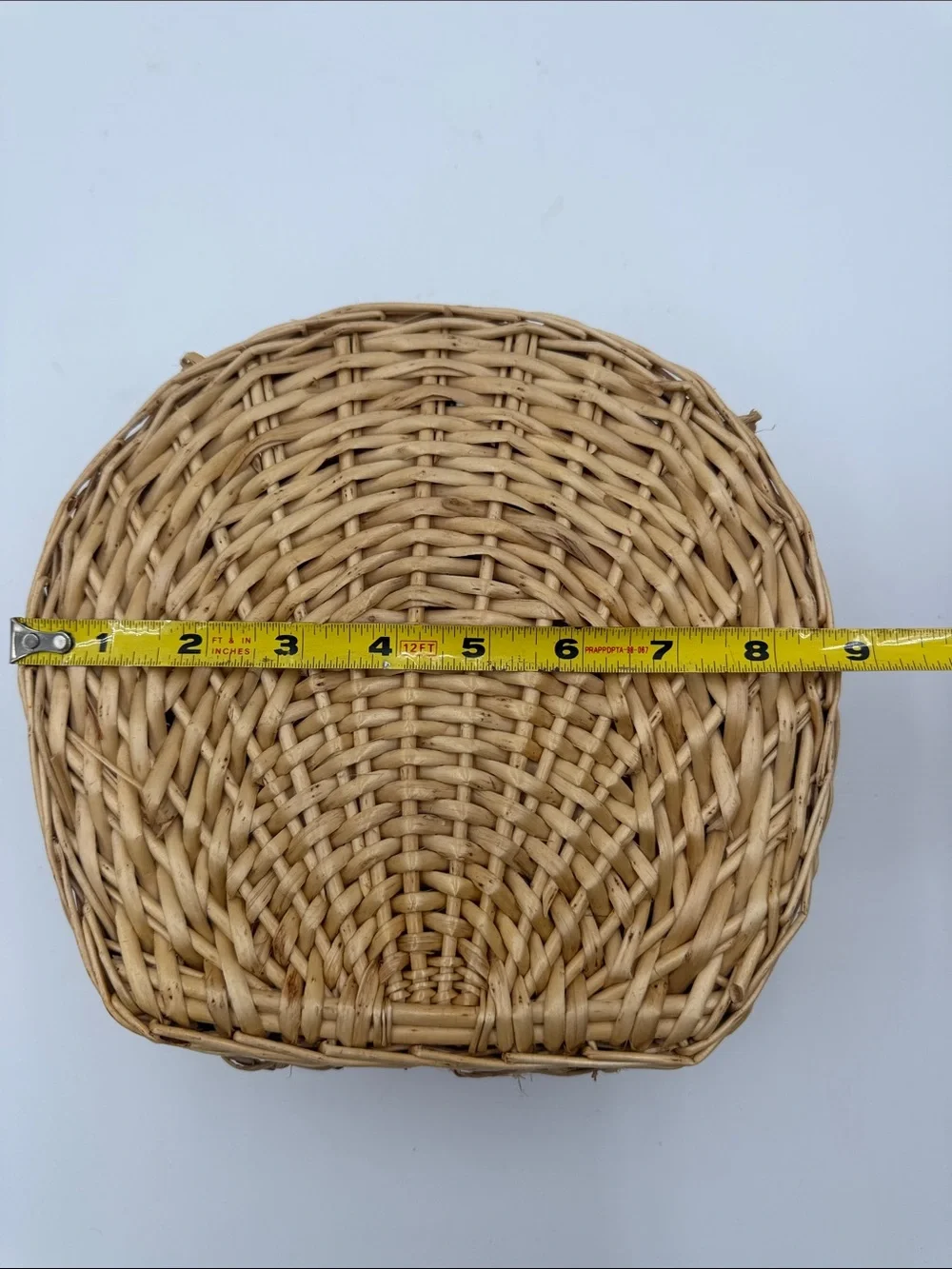 A Cute, charming vintage shell-shaped rattan storage basket with a front handle.